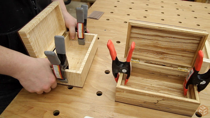 a small wooden box with hand tools