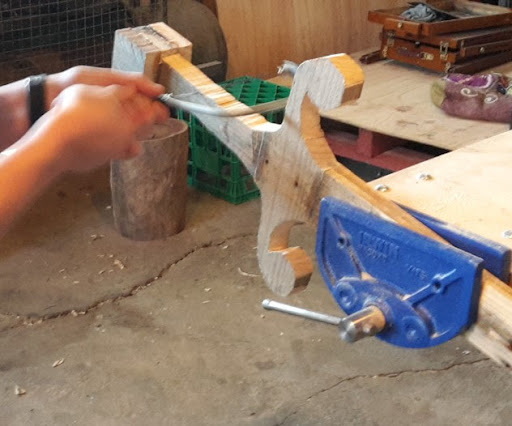 a wooden sword with hand tools
