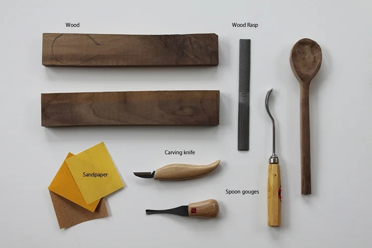 a wooden spoon with hand tools