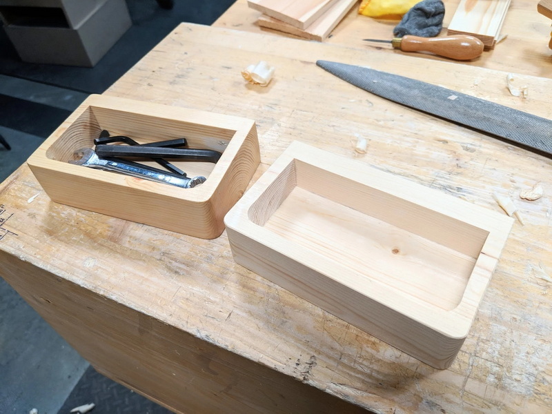 a wooden box with hand tools